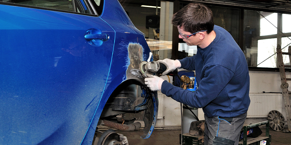 Image Of Employee Fixing Vehicle